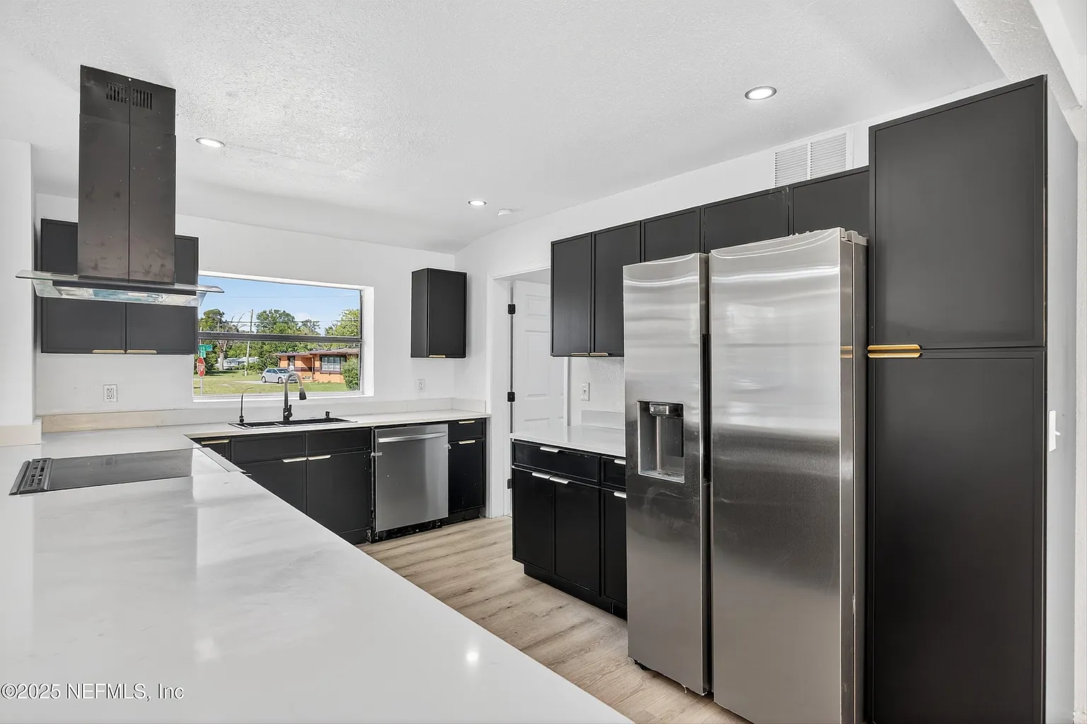 Modern kitchen with matte black cabinets and stainless appliances